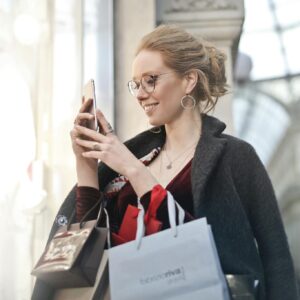 Woman Standing Near Wall Holding Phone